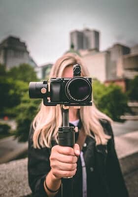 social-media-video-marketing-tips-for-small-businesses-woman-holding-camera-clio-websites