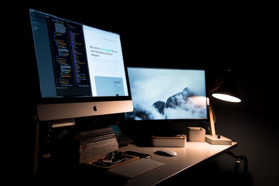 is-it-worth-paying-for-a-web-designer-computer-desk-dark-background