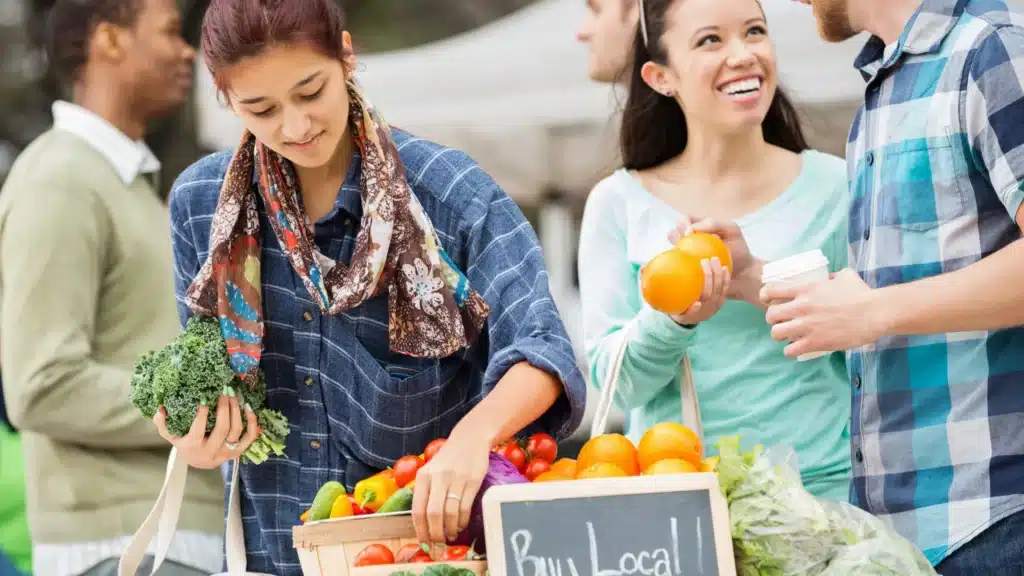 how to market your small business locally - buy local woman buying produce
